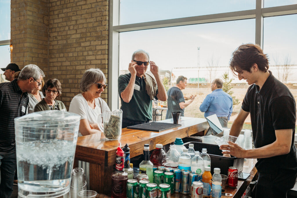 Focus Financial clients ordering complementary beverages at the wet bar