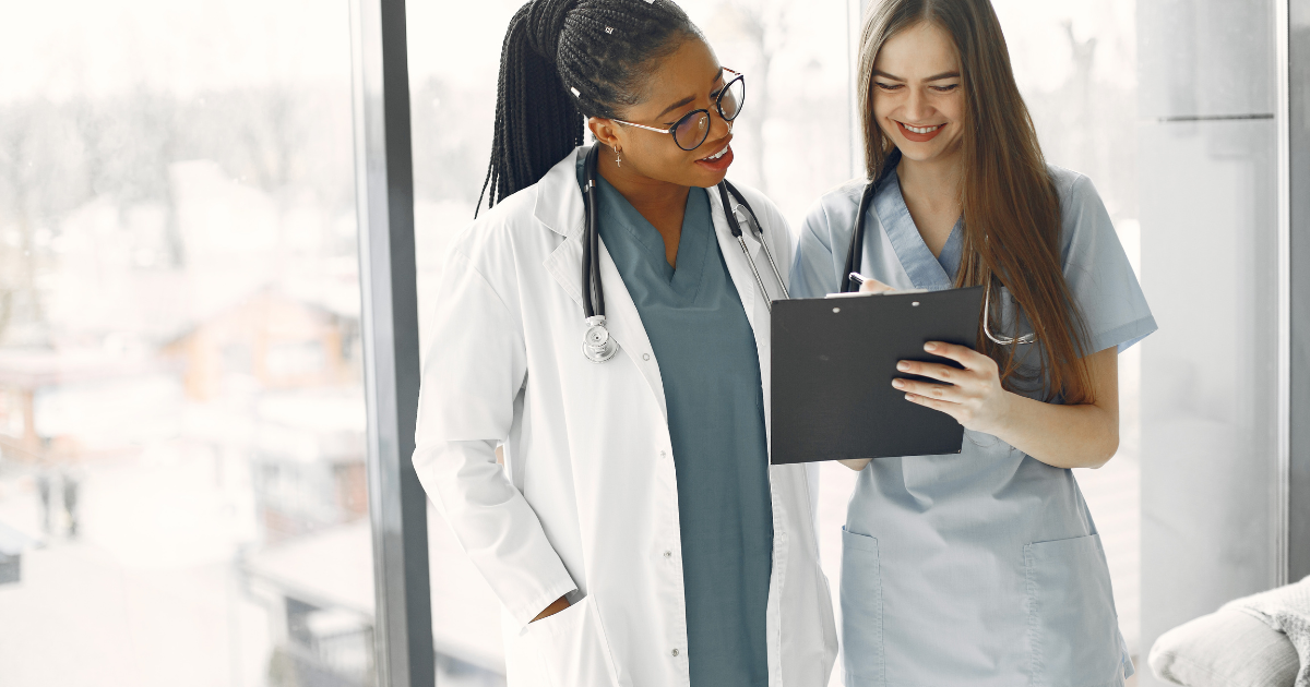 A female doctor and female nurse are pictured looking at a healthcare directive to ensure they respect their patient's wishes.