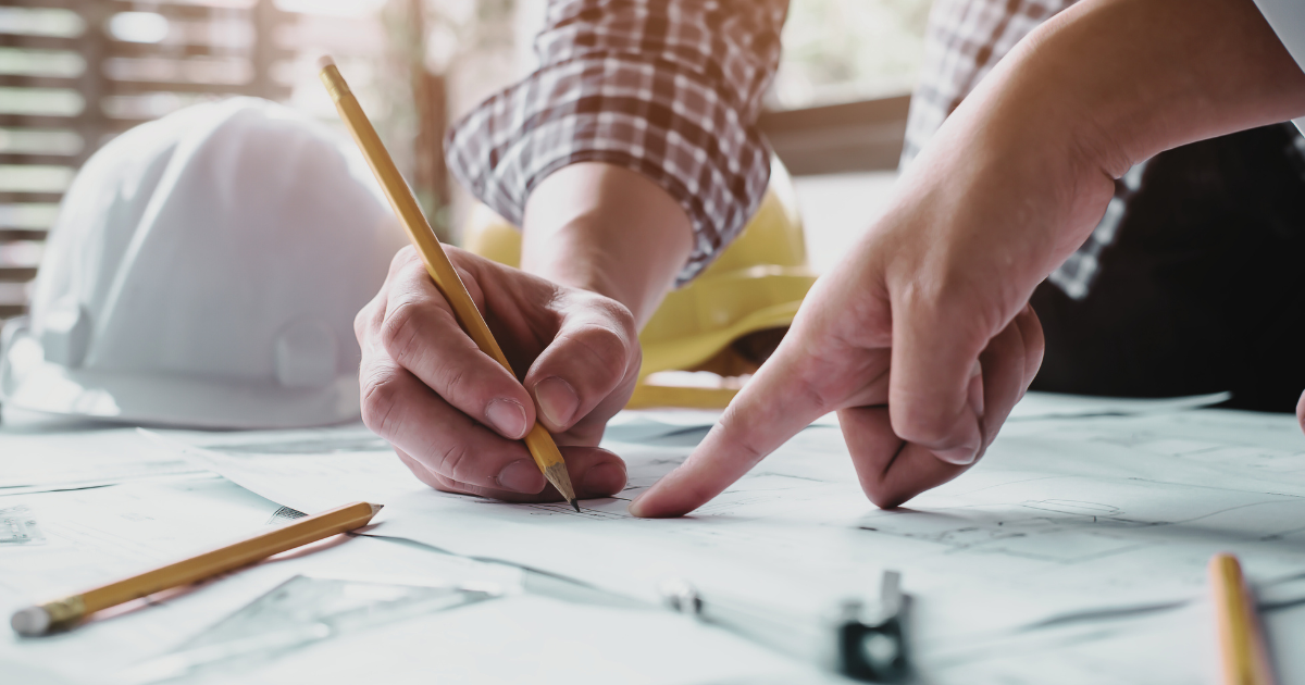 A photogrpaph of two MedTech Professionals analyzing their plans to illustrate the unique approach Perspective 6 Group takes when working with industry professionals.